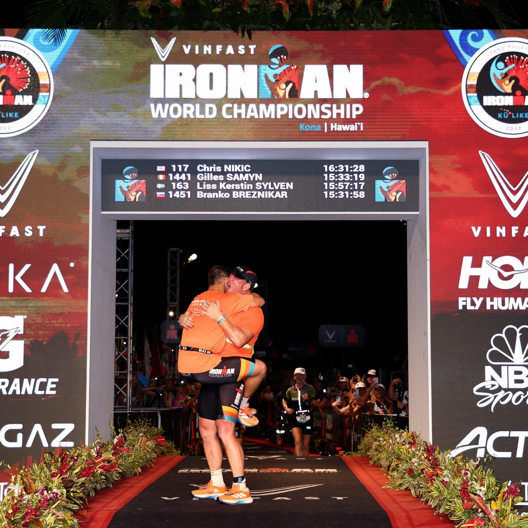IRONMAN World Championship KAILUA KONA, HAWAII - OCTOBER 06: Chris Nikic and guide Dan Grieb celebrate after finishing the Ironman World Championships on October 06, 2022 in Kailua Kona, Hawaii. (Photo by Tom Pennington/Getty Images for IRONMAN)