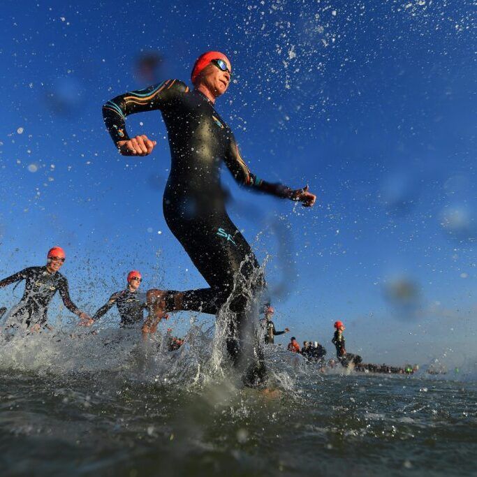 Isuzu IRONMAN 70.3 World Championship Women PORT ELIZABETH - SEPTEMBER 1: General view of Age Group Athletes entering the water for the swim start during the Isuzu IRONMAN 70.3 World Championship Women in Port Elizabeth, South Africa on September 1, 2018. Over 4,500 athletes from over 100 countries will be represented in this years 70.3 World Championship. (Photo by Donald Miralle/Getty Images for IRONMAN).
