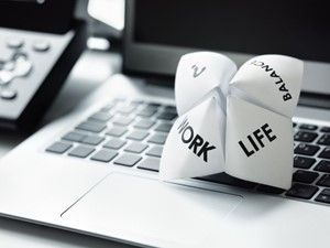 Paper fortune teller on a laptop keyboard, labeled