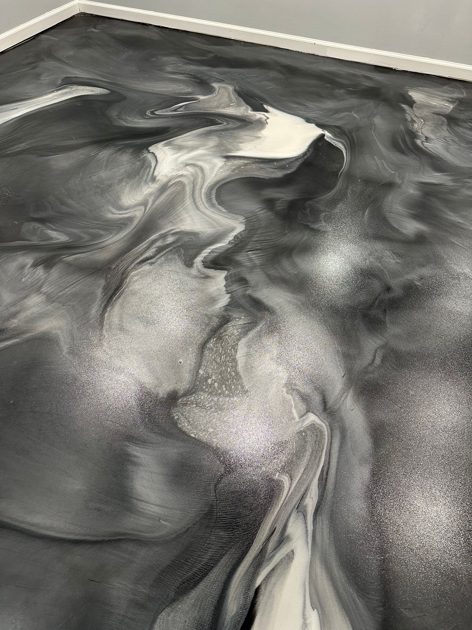 Black and white marbled abstract surface with swirling, flowing patterns