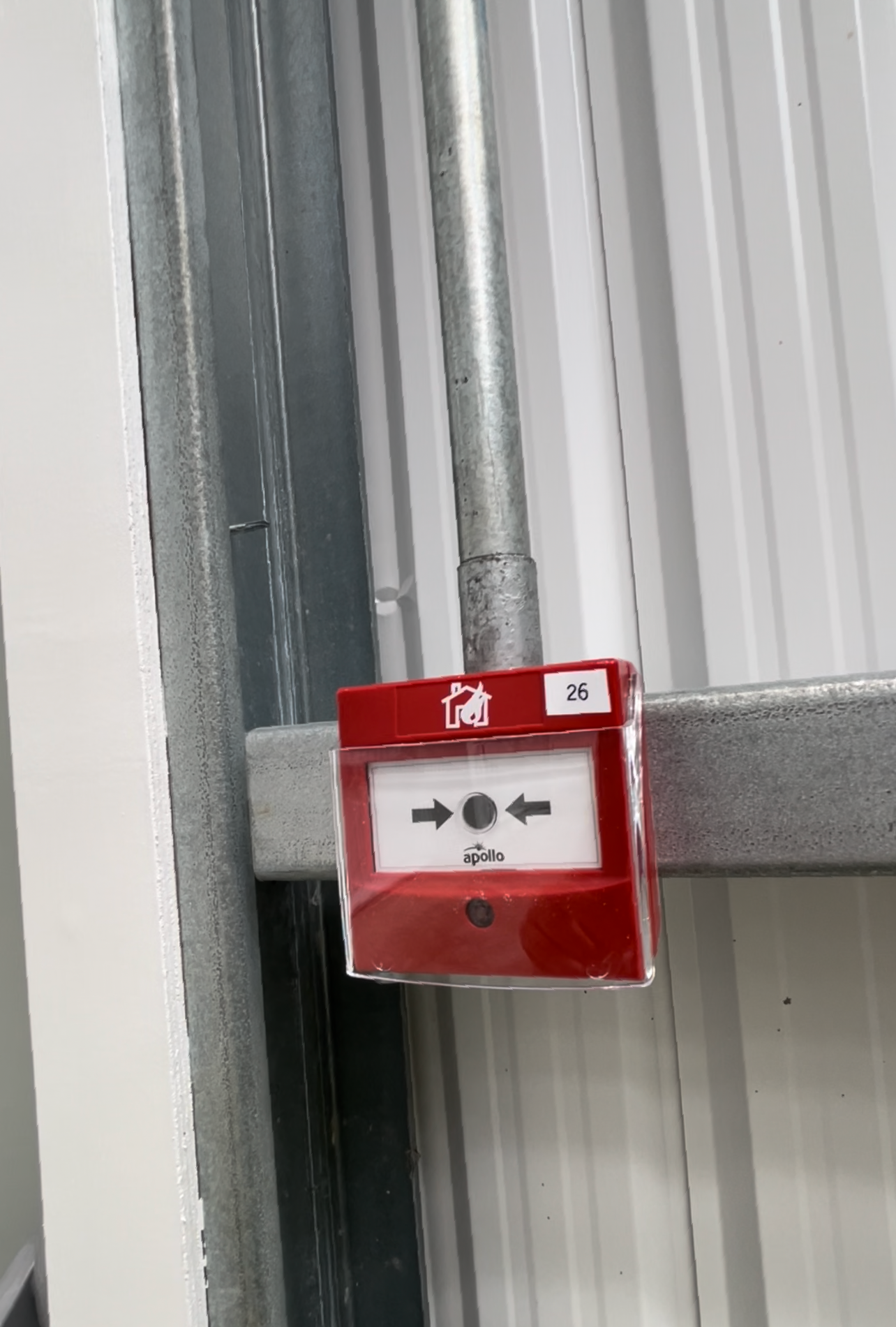 A manual Call Point in a warehouse with steel cond
