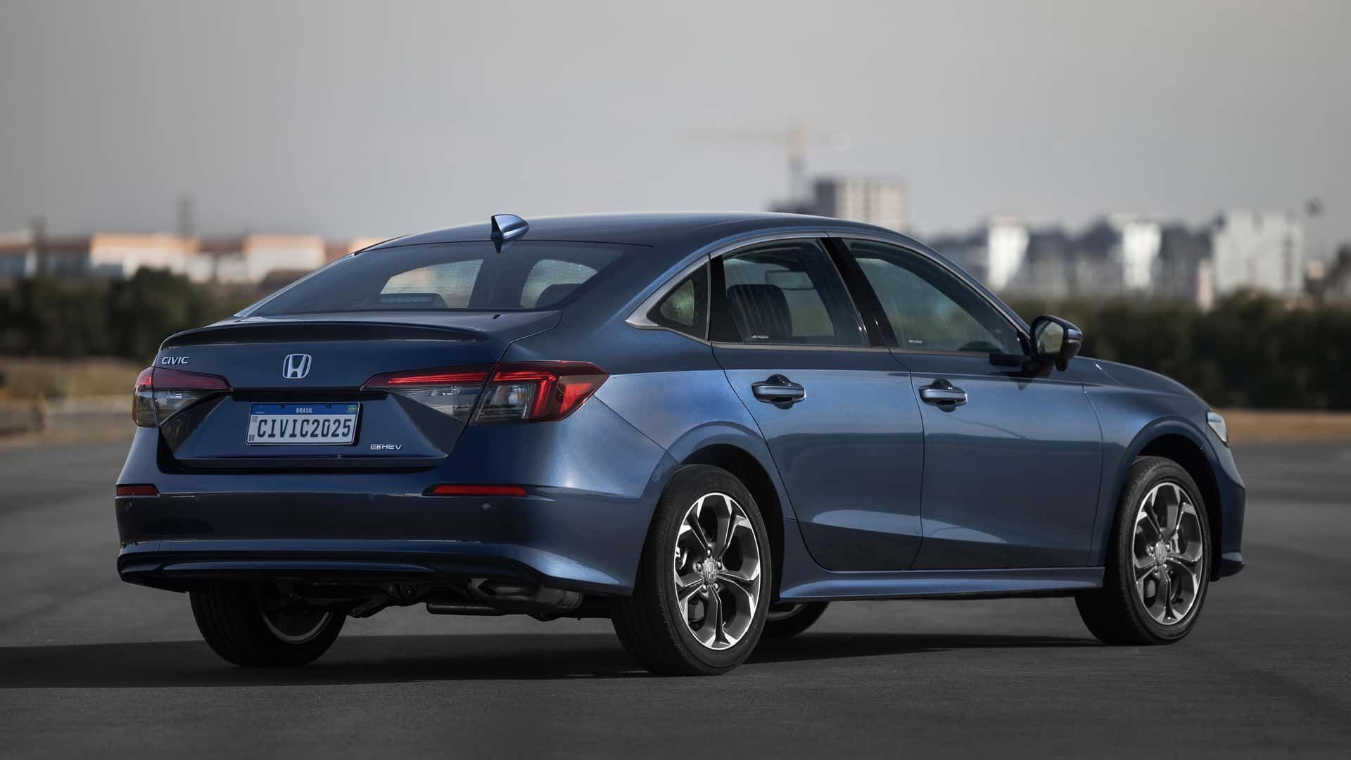 Blue sedan car parked on a road with a city skyline in the background