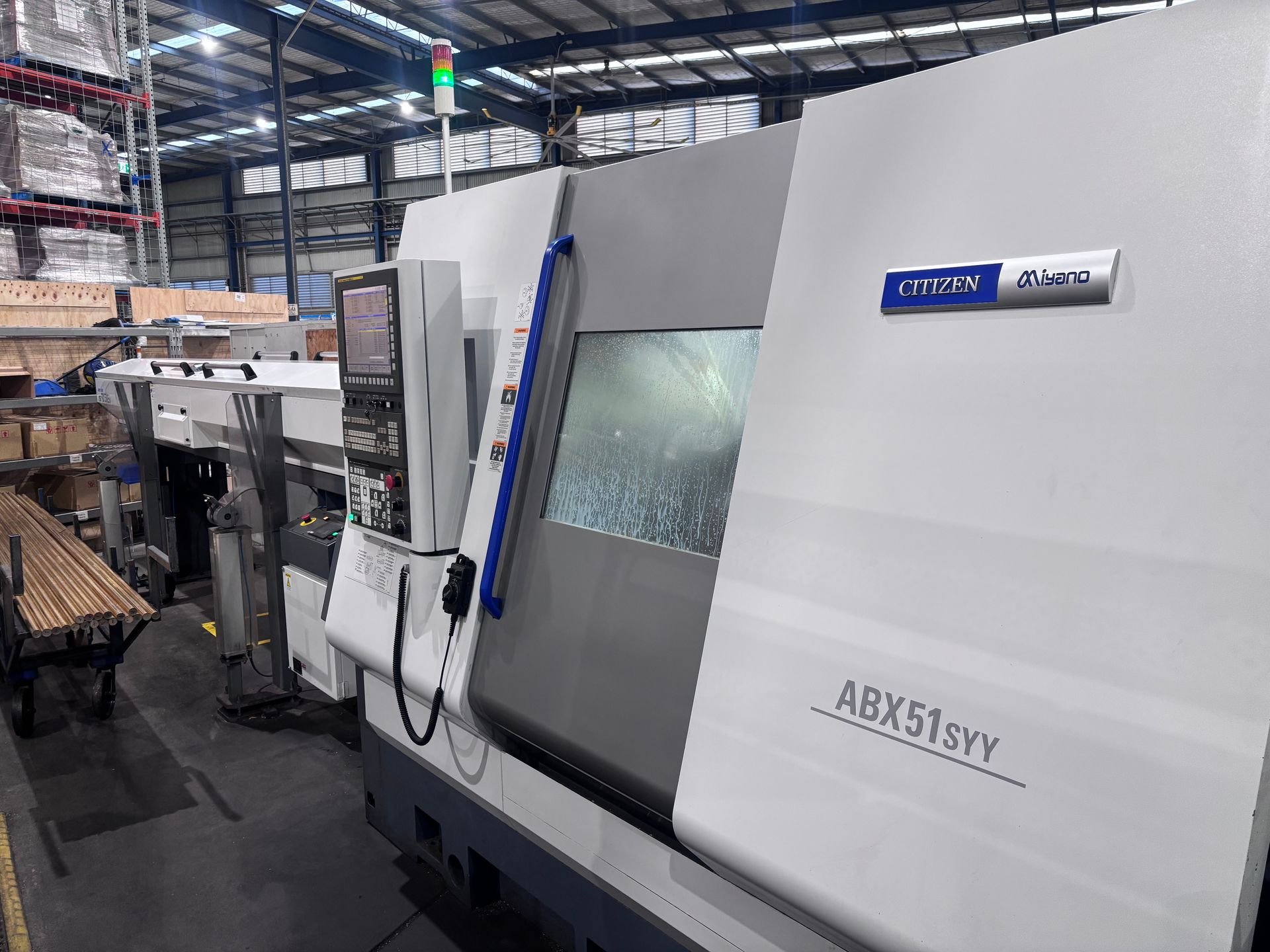 A machine is sitting in a warehouse next to a couch.