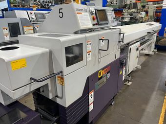 A large machine is sitting on the ground in a factory.
