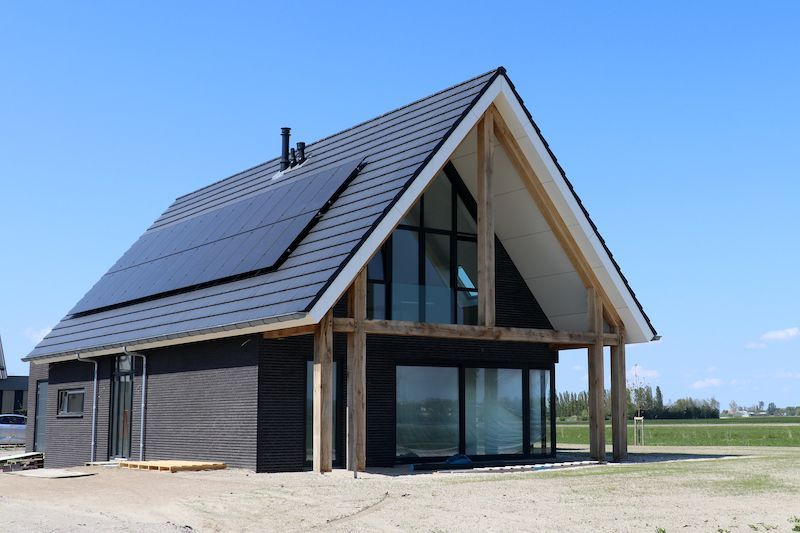 Een huis met een dak waar zonnepanelen op liggen