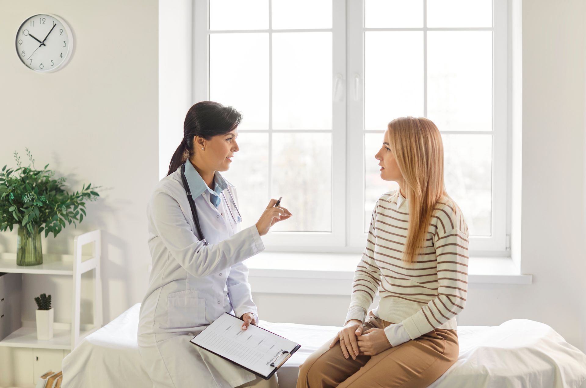 Female doctor consulting a young woman patient at a clinic
