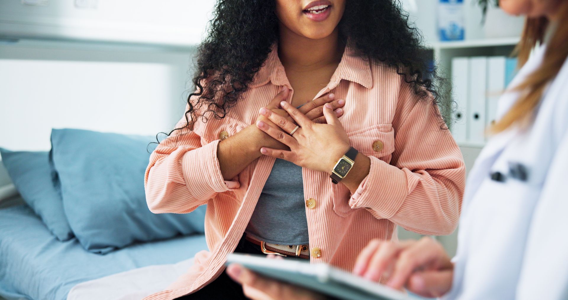 Physician consulting with a female patient in a private exam room Physician consulting with a female patient in a private exam room