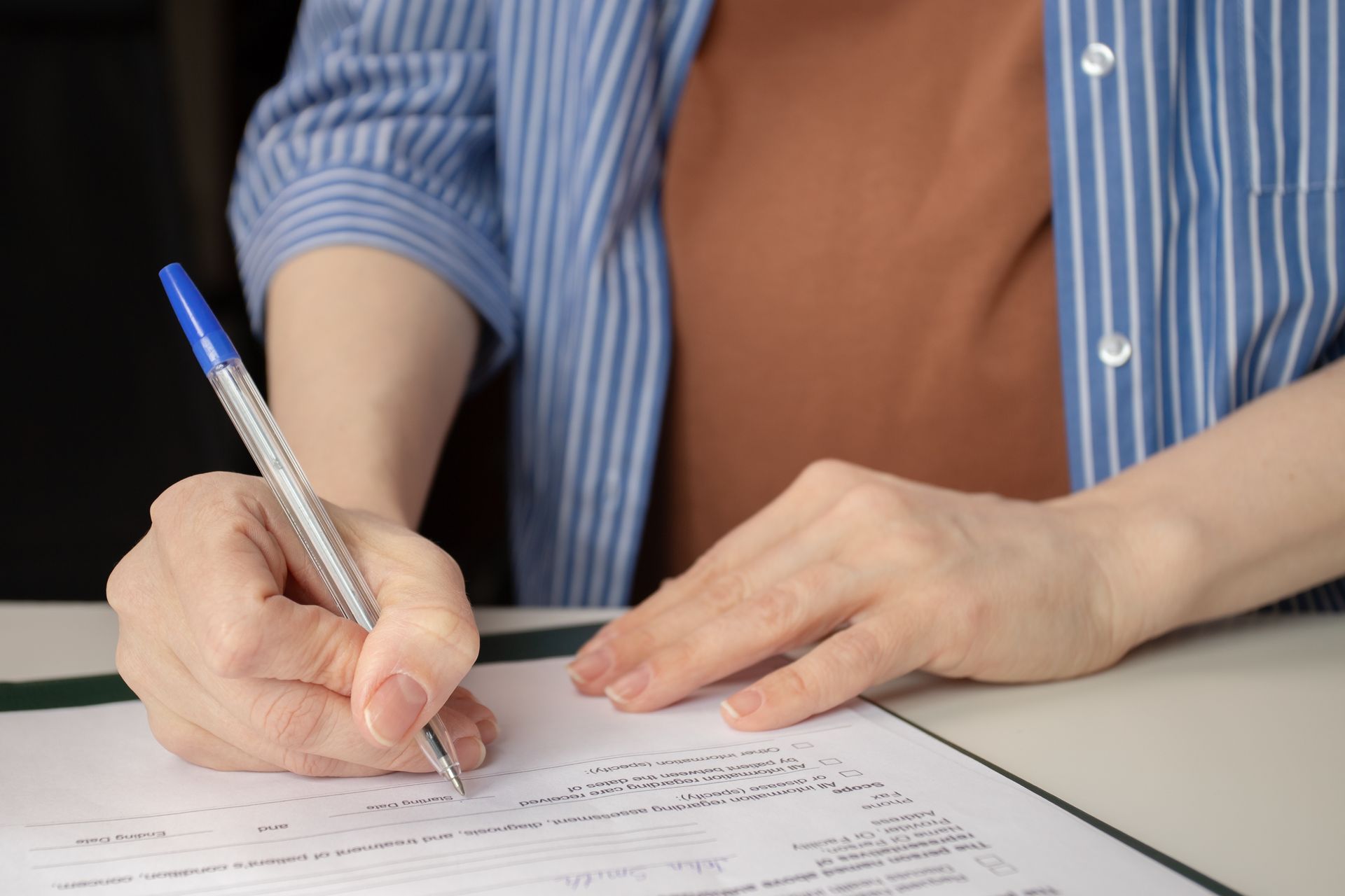 Woman signing consent form for Safe Abortion Services.