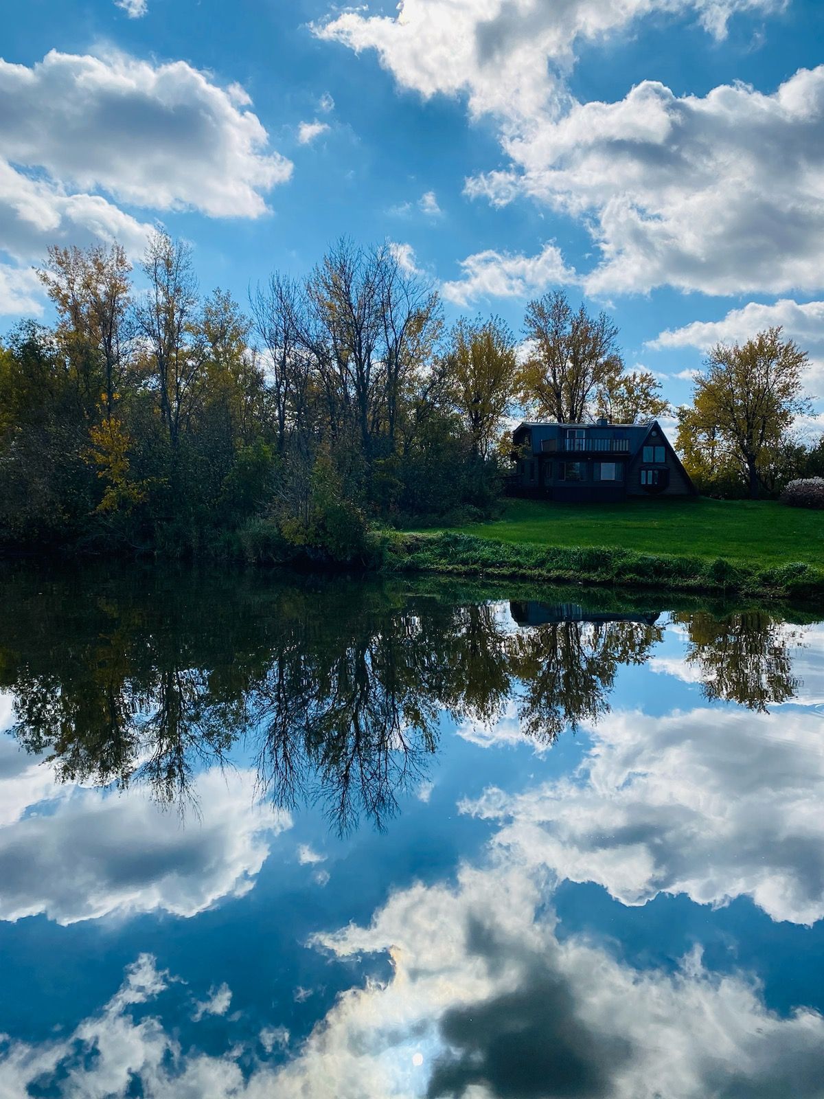 A beautiful lake home and lake house owned by an experienced lake home owner. The sky reflects beautifully in the lake water.