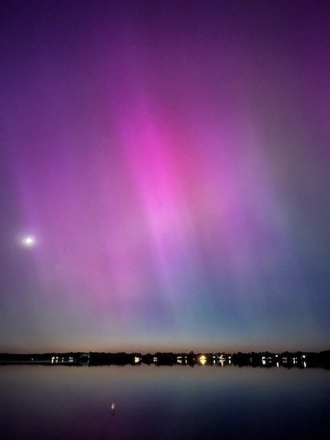 Purple and blue northern lights over a lake in MN. Taken by an experienced lake home owner