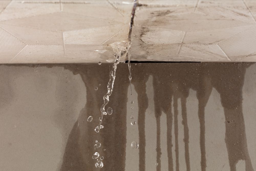 Water Leaking From Ceiling Tiles, Creating Dark Water Stains and Drips — Ultimate Restoration Services in Koongal, QLD