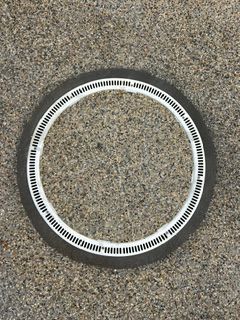 Black and white circular ring on a speckled gray surface