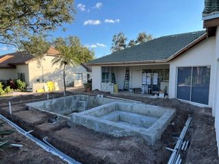 Backyard patio with newly built concrete garden planters in front of a house