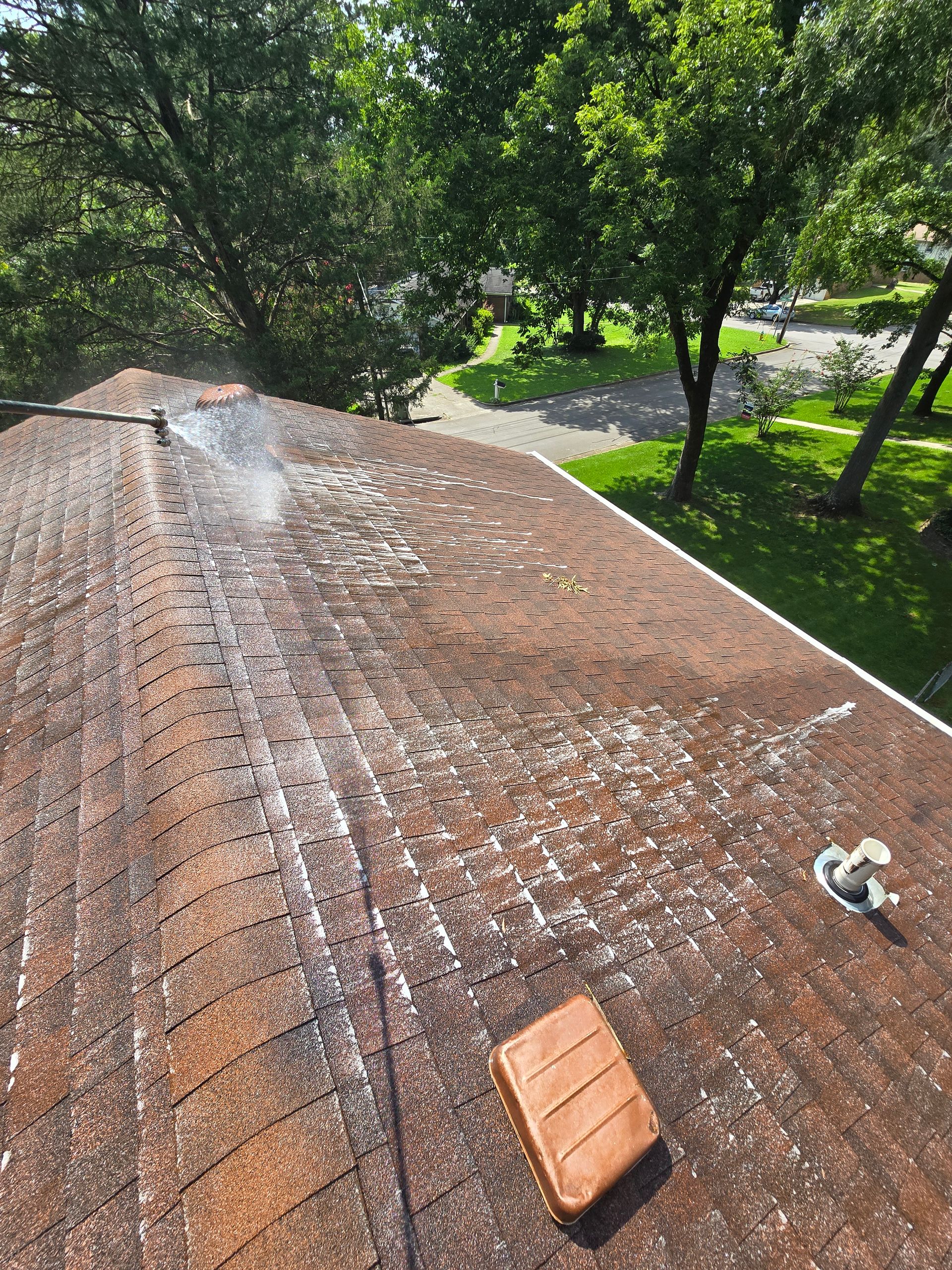 Een dak wordt gereinigd met een hogedrukreiniger