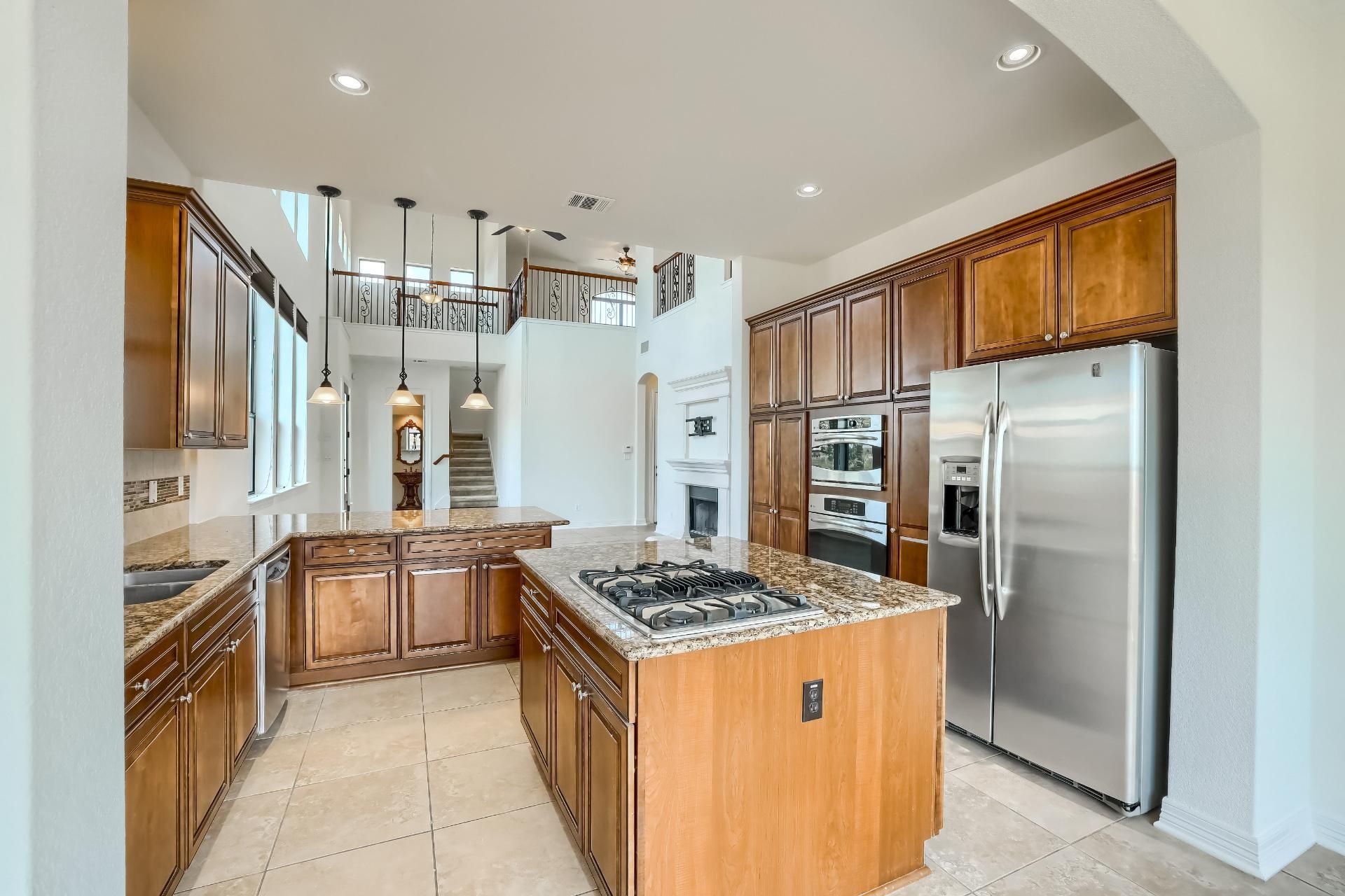 A kitchen with stainless steel appliances, including a refrigerator, stove, oven, and dishwasher.