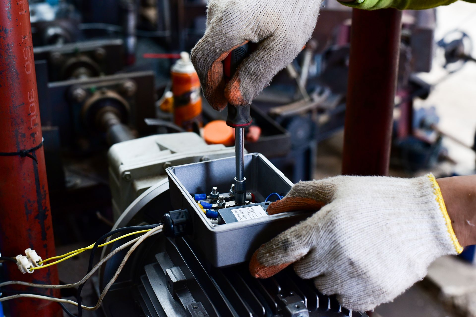 Electricians working on industrial panels, installing and assembling new wires.