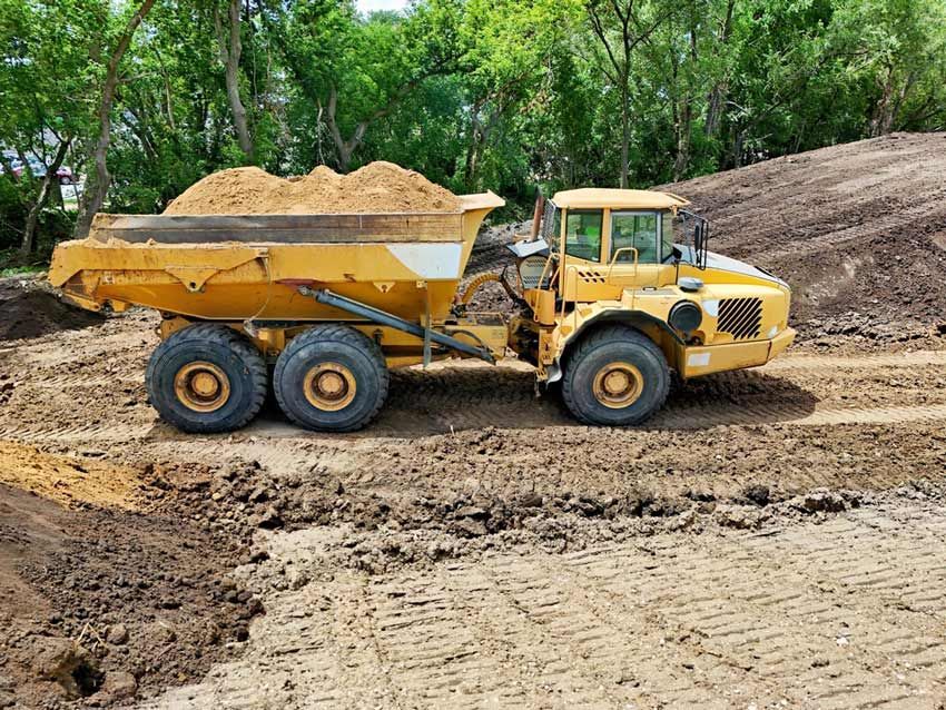 Large Earth Moving Dump Truck Loaded With Sand — Austen Landscaping & Earthmoving in Deeragun, QLD