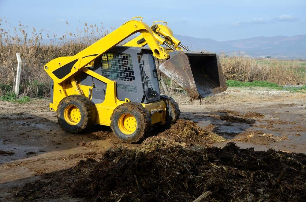 Yellow Bobcat Working On The Site — Austen Landscaping & Earthmoving in Deeragun, QLD