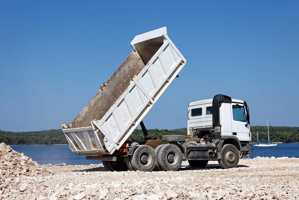 Tipper Truck Unload Crushed Rocks — Austen Landscaping & Earthmoving in Deeragun, QLD