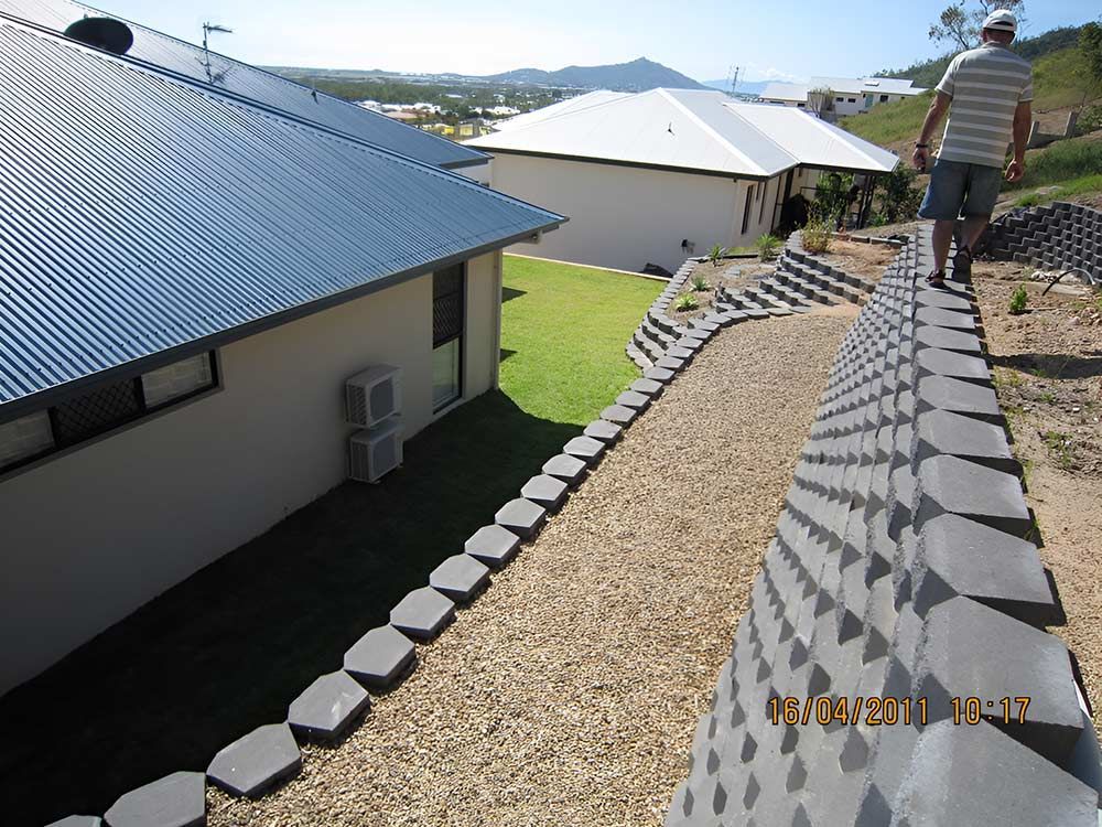 Garden with stone and lawn — Landscaper in Deeragun QLD