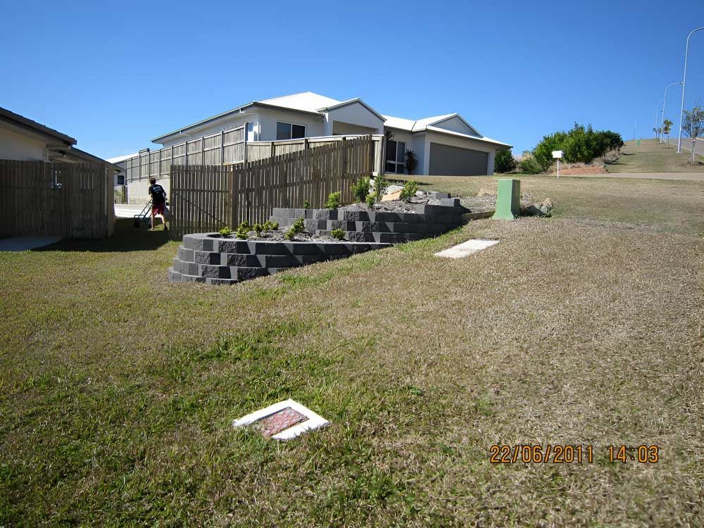 A House With A Front Lawn And A Surrounding Fence — Austen Landscaping & Earthmoving in Deeragun, QLD
