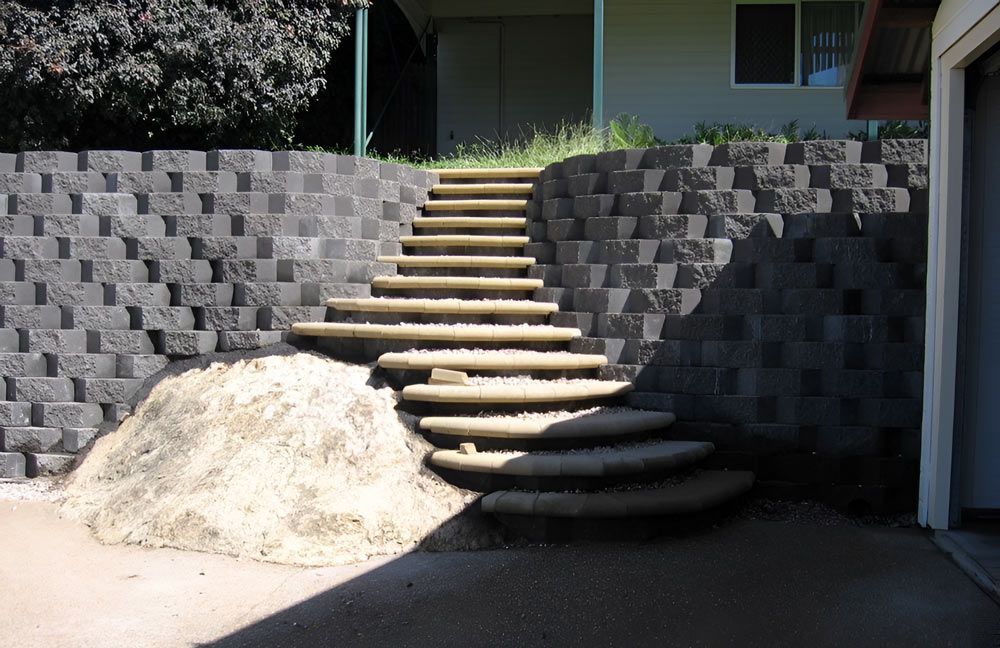 A Set Of Stairs Leading Up To A House With Brick Walls — Austen Landscaping & Earthmoving in Deeragun, QLD