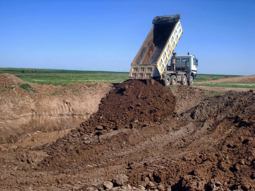 View Of Dump Truck Dumping Gravel — Austen Landscaping & Earthmoving in Deeragun, QLD