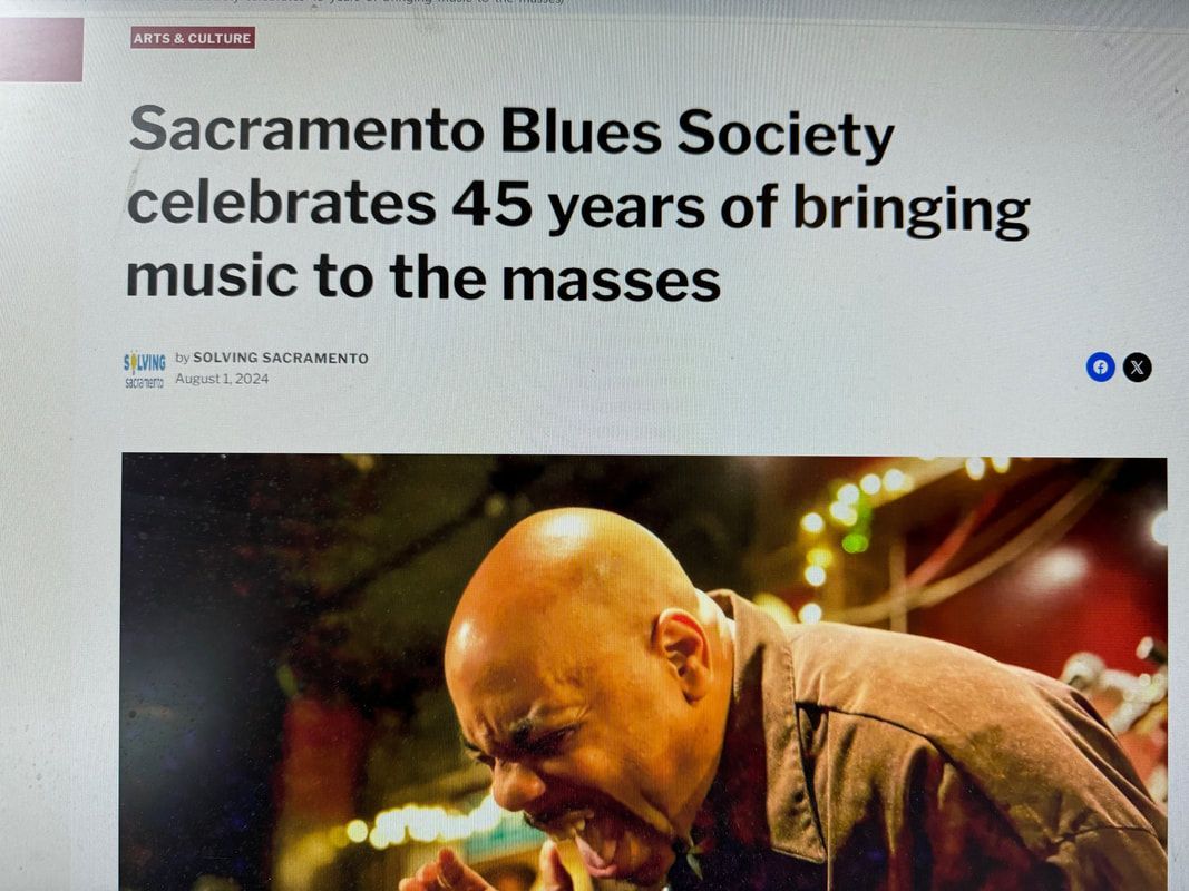 Sacramento Blues Society article headline above a musician performing onstage under warm lights