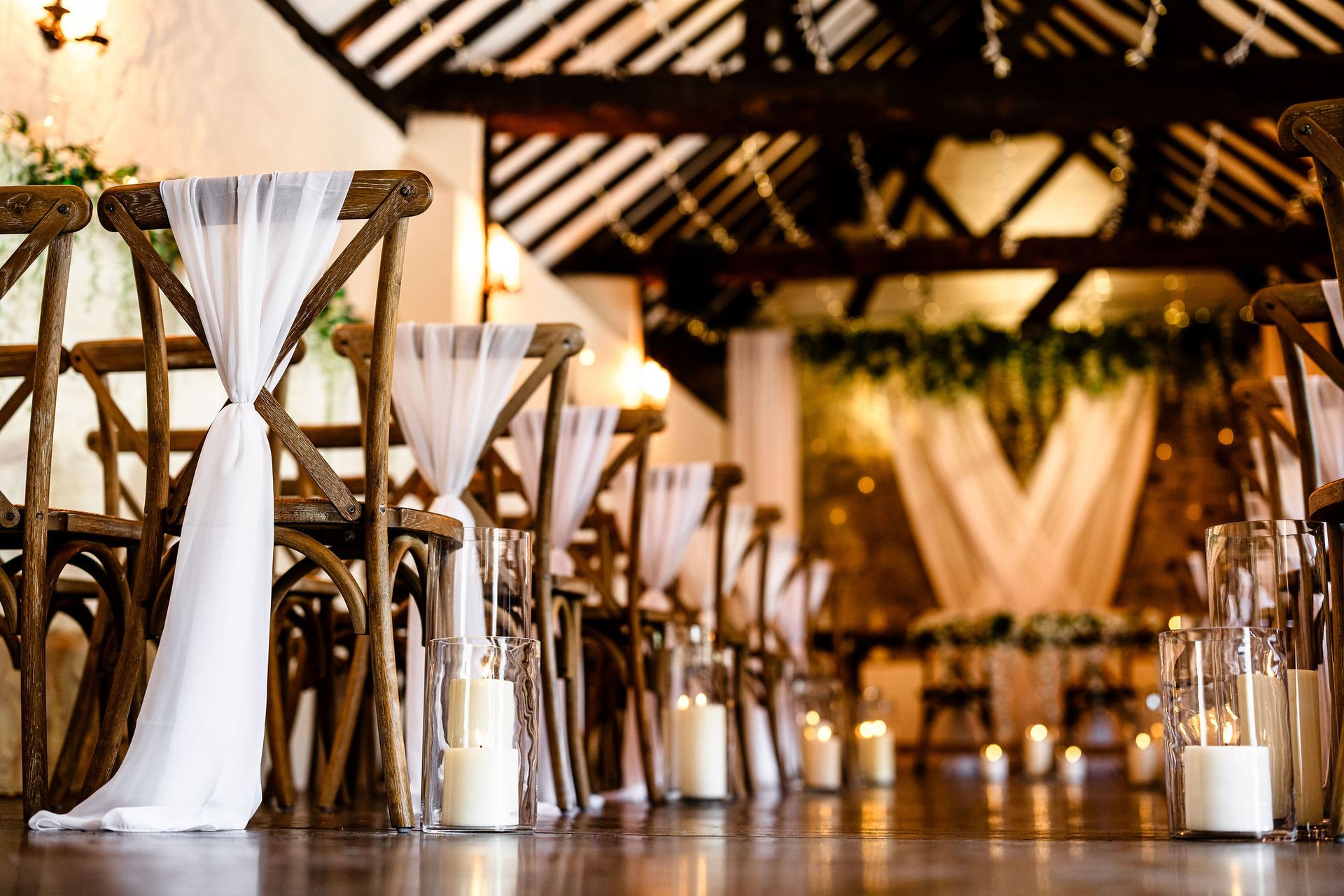Outdoor restaurant with warm string lights under a curved wooden roof at dusk
