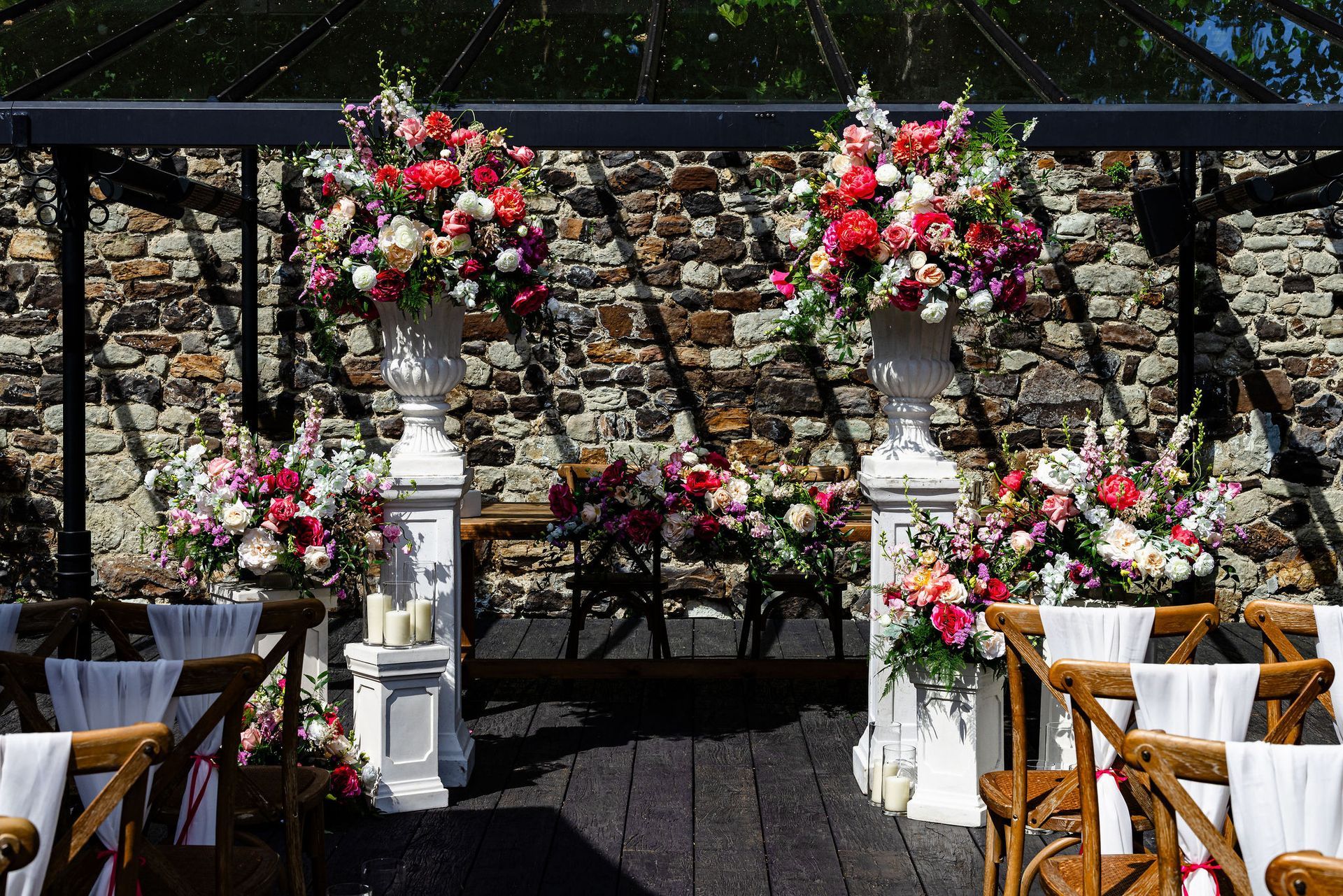 Bride and groom kissing at the altar during a rustic indoor wedding ceremony