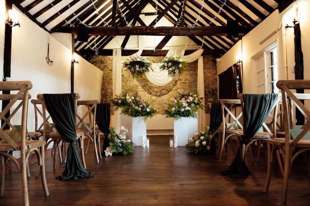 Outdoor wedding ceremony with bride in white gown at aisle’s end, guests seated on both sides