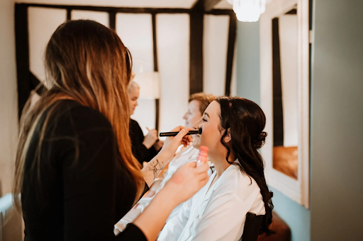 Serene, light-filled pamper room with plush seating for relaxed bridal morning preparations.