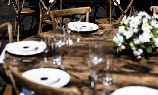 Vibrant Texas-style smokehouse buffet feast set on rustic wooden tables for a twilight wedding.