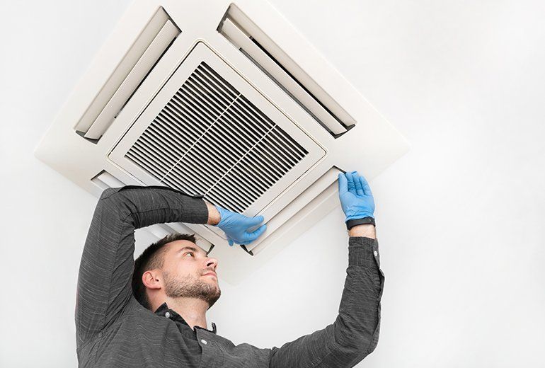 Man checking up the aircon