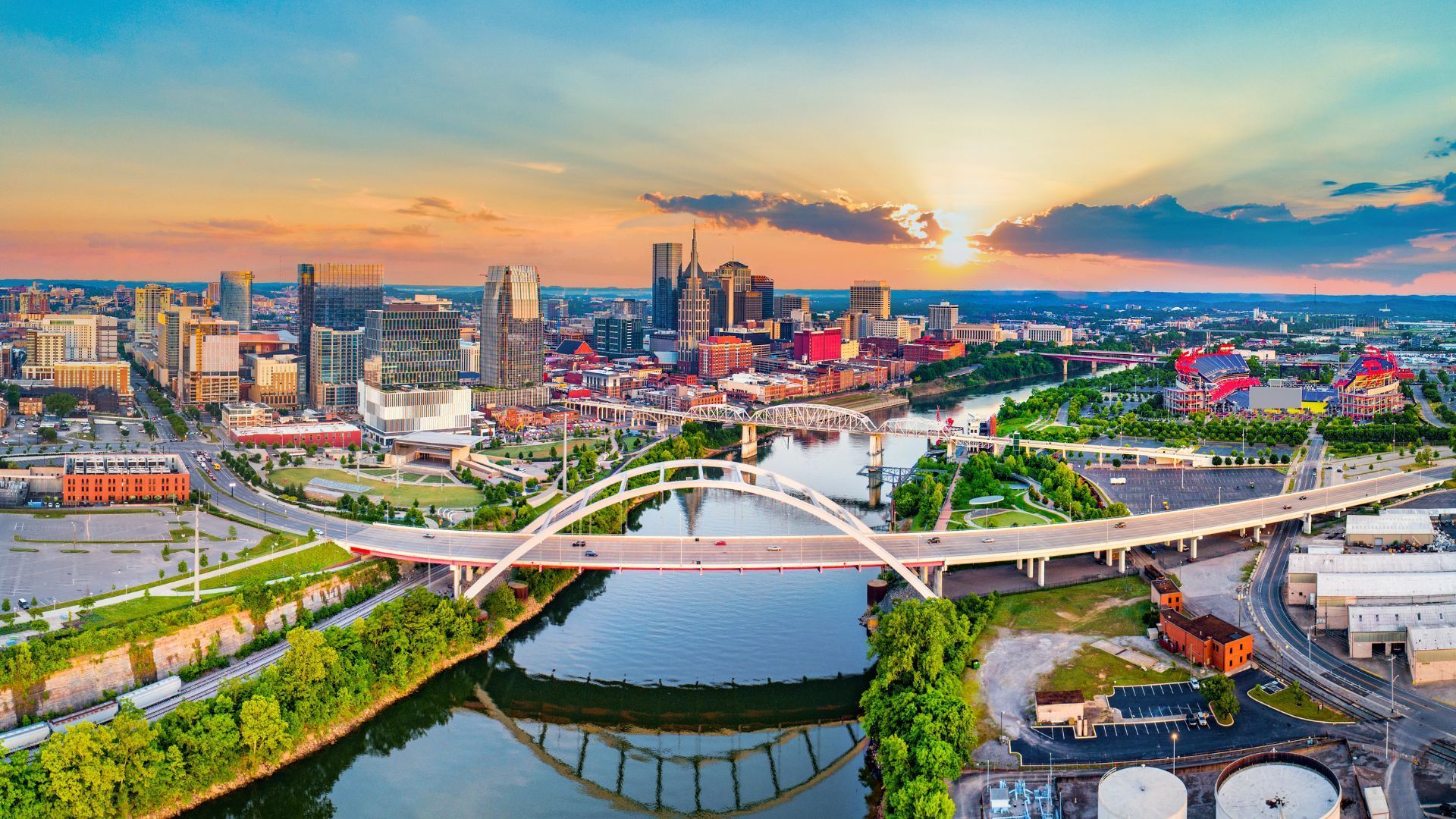 An aerial view of a city with a bridge over a river.