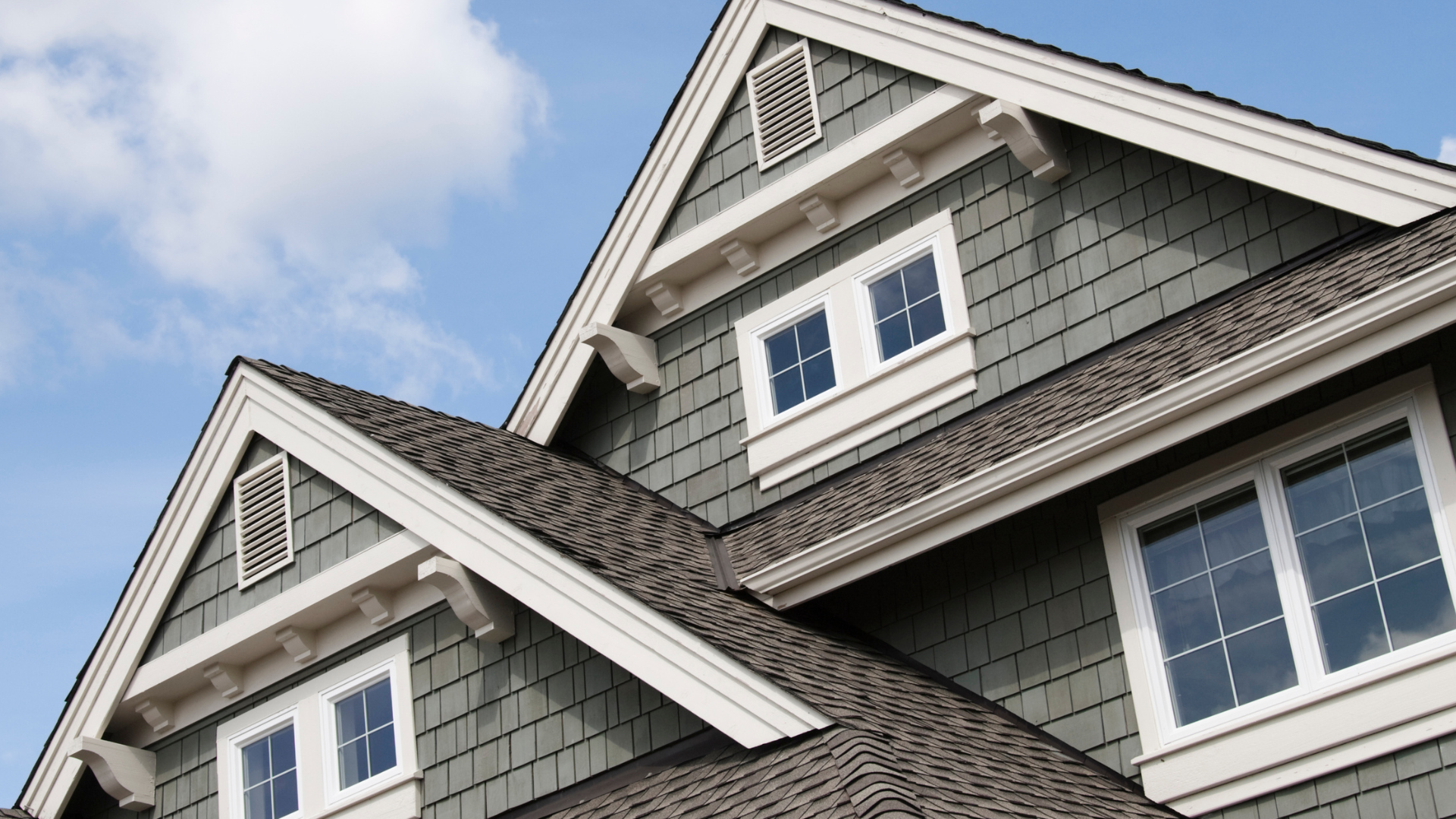 The roof of a house with a blue sky in the background.