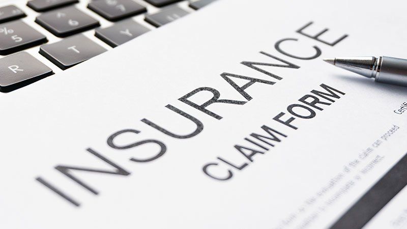 Pen resting on insurance claim form