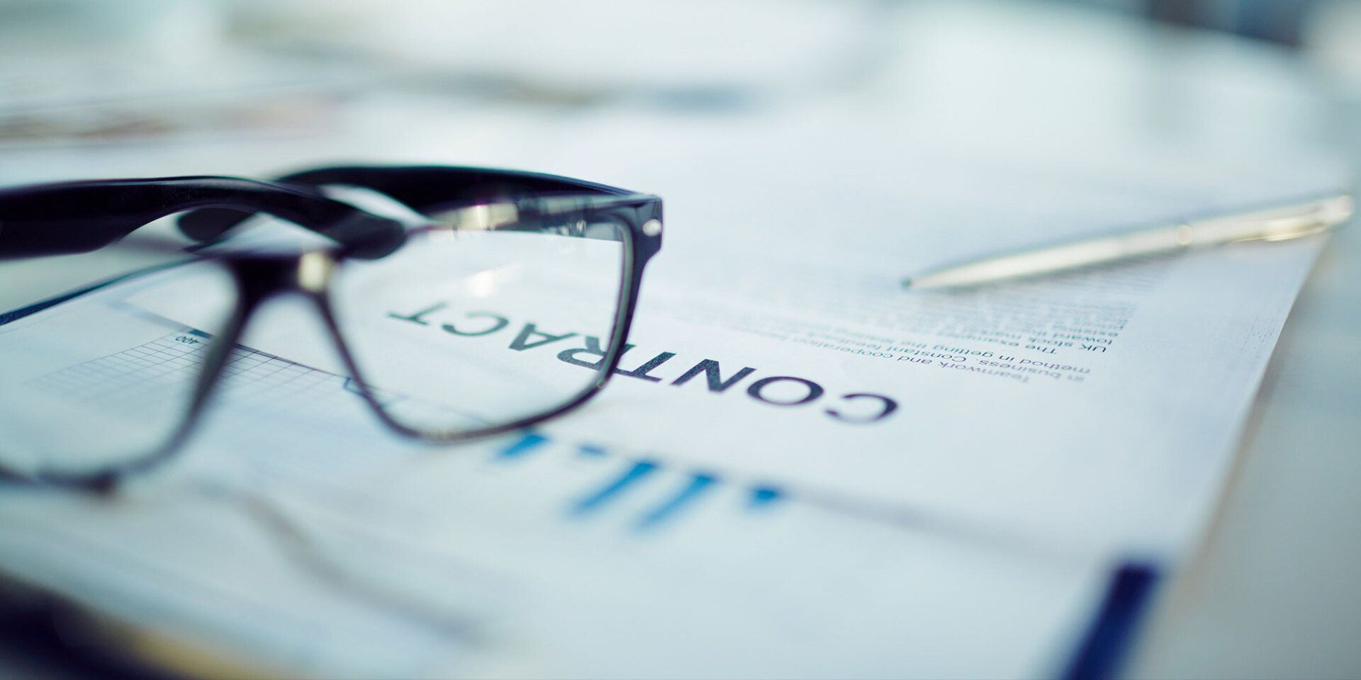 glasses lying on a contract