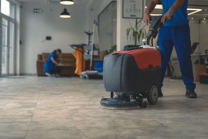 scrubber machine while other cleaner cleans 