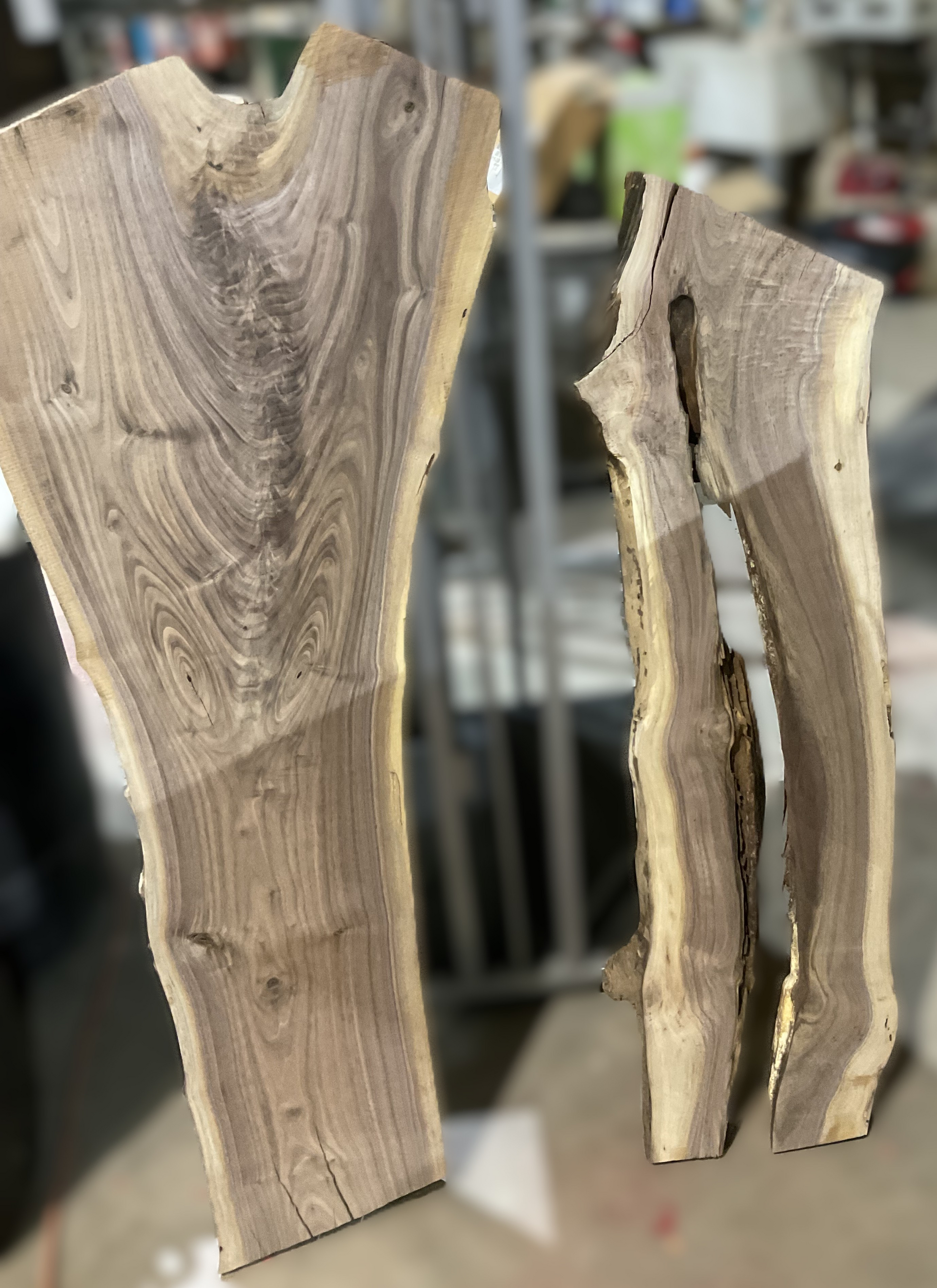 Two pieces of wood are sitting on top of a table.