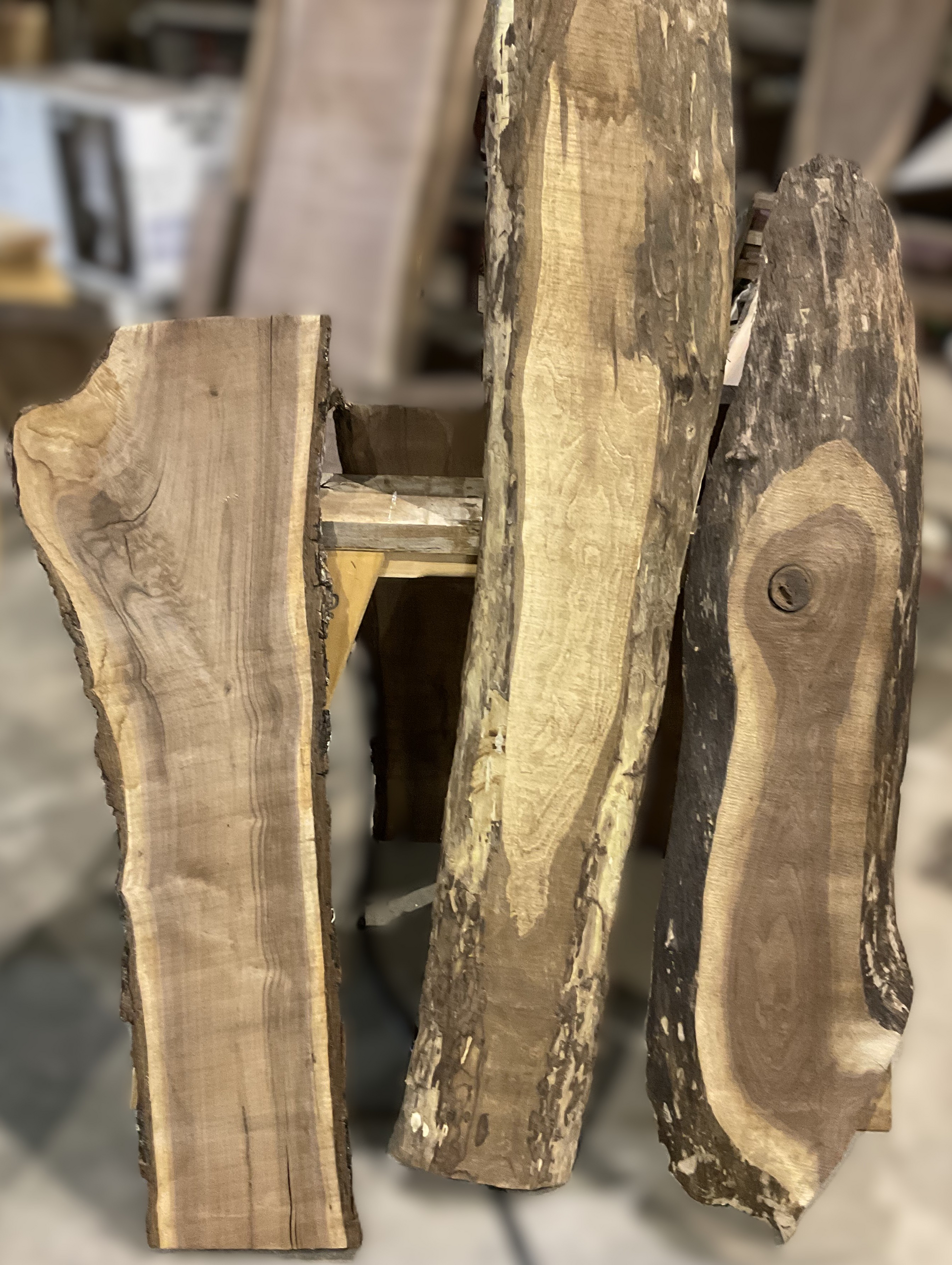 Three pieces of wood are sitting next to each other on a table.