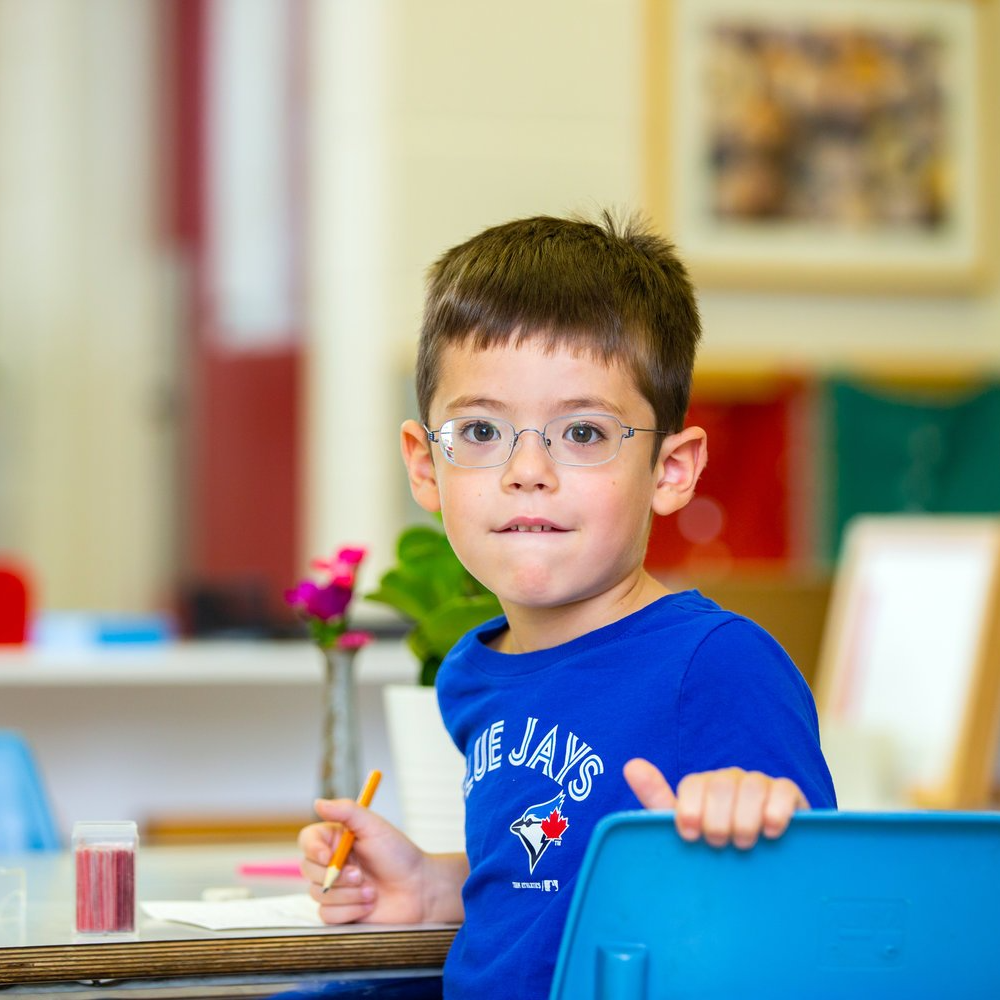 Montessori child looking at the camera