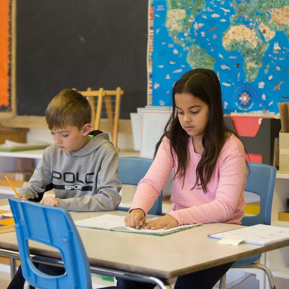 Lower Elementary Montessori children working in the classroom