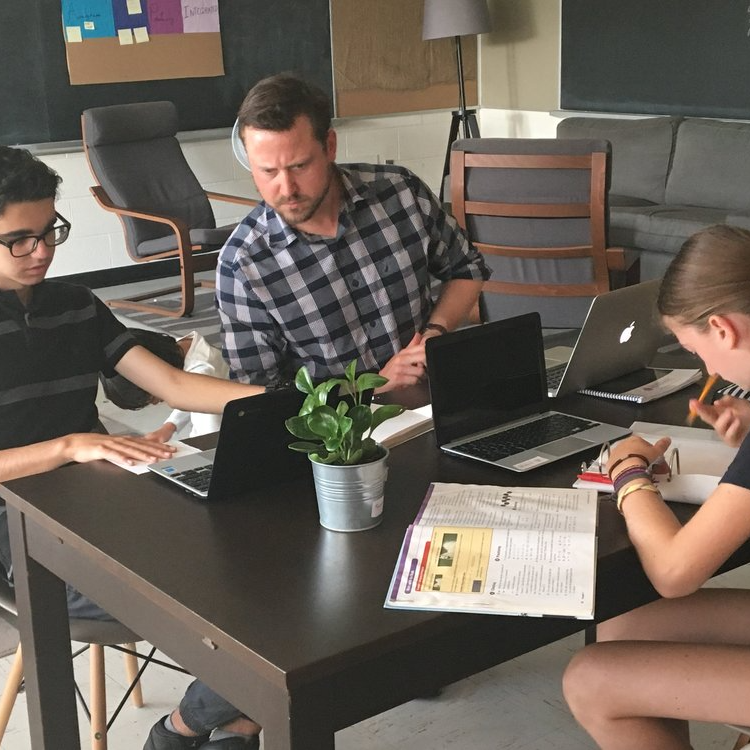 Montessori students and guide in the classroom
