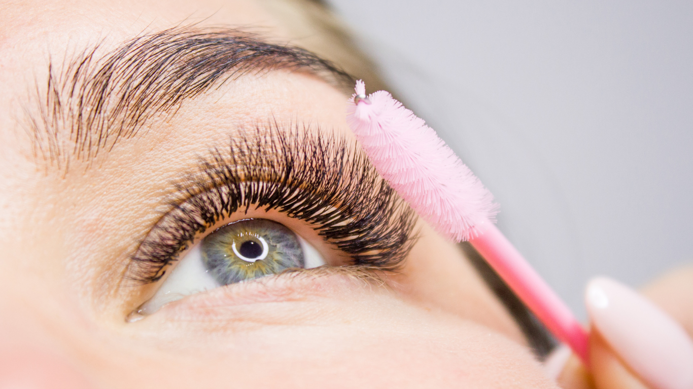 Beauty specialist applying treatment to a client's face in a bright spa salon
