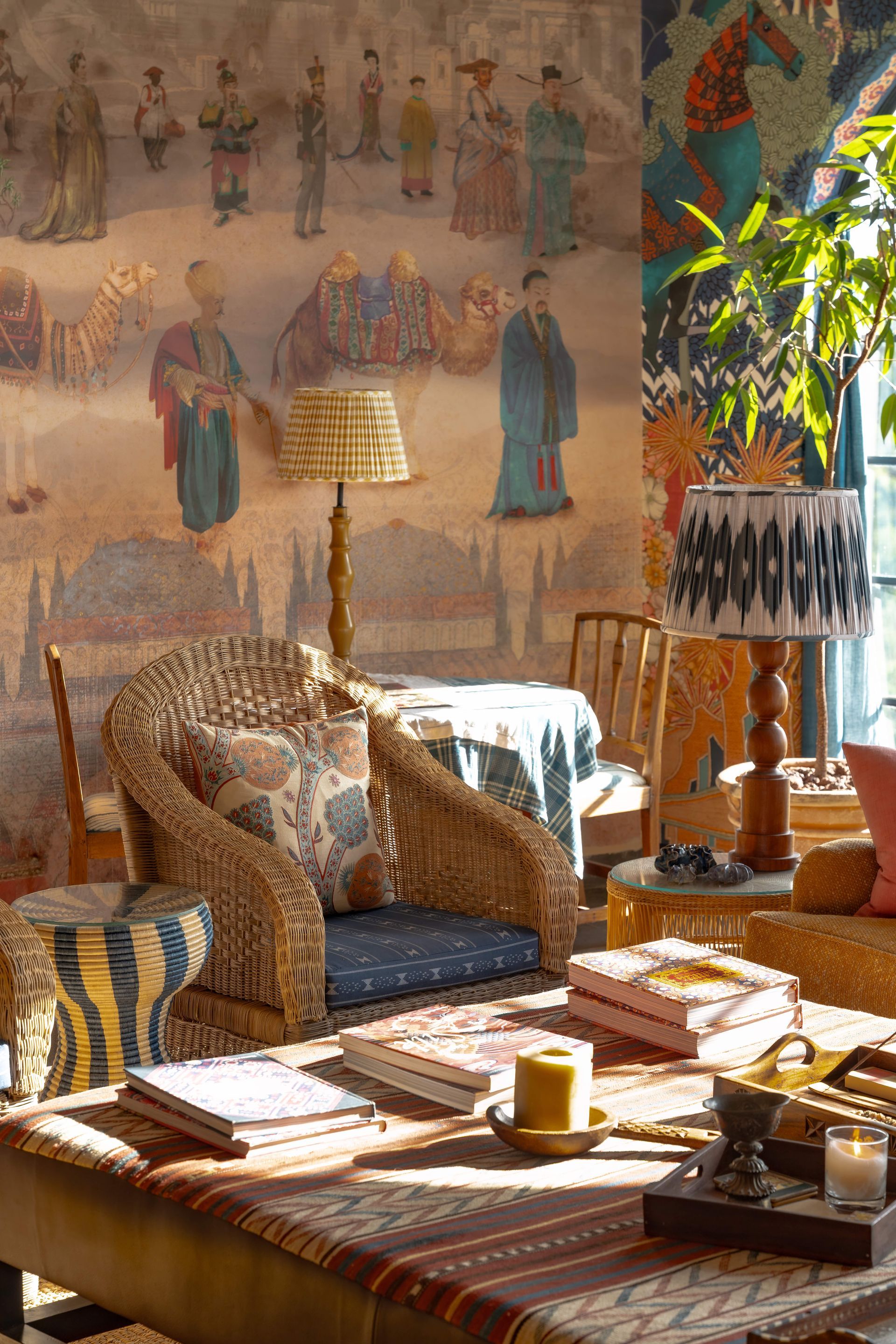 Cozy bohemian living room with patterned sofas, wooden table, and warm sunlight by a wall mural