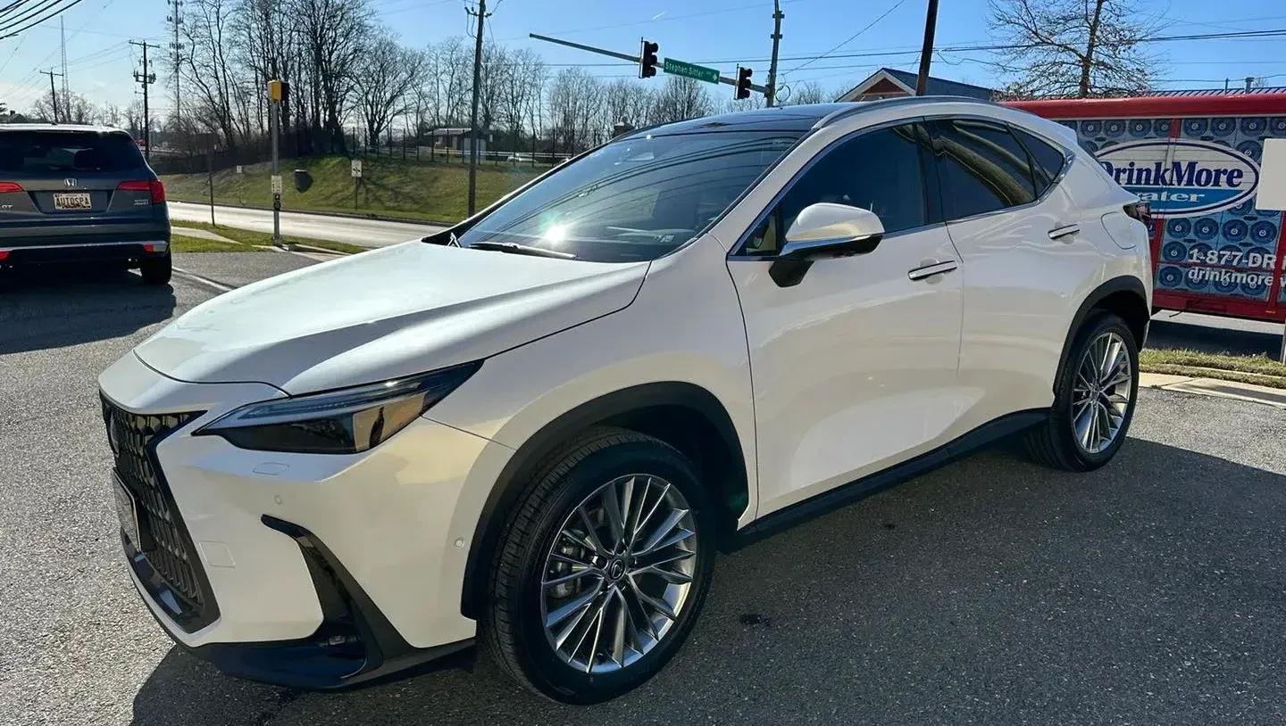 A white lexus nx is parked on the side of the road.