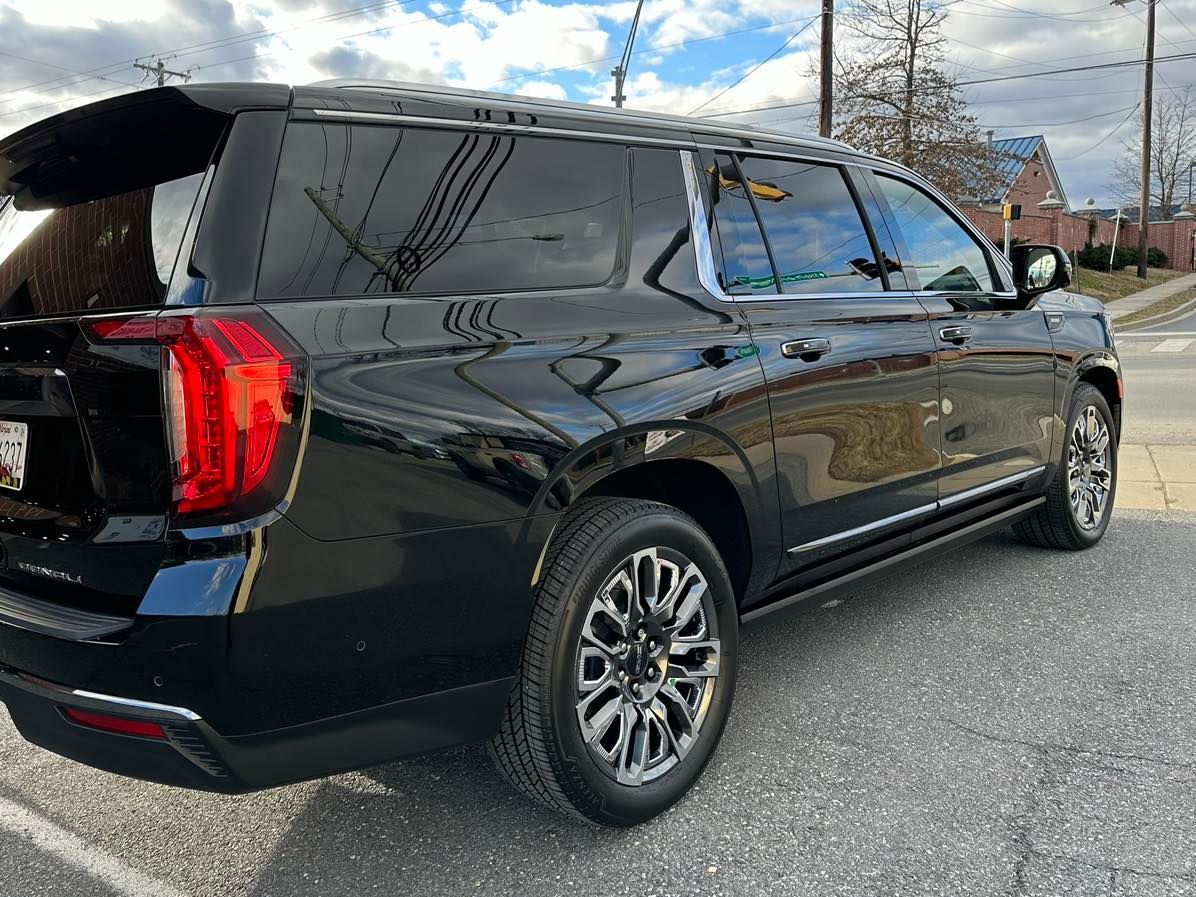 A black suv is parked on the side of the road.