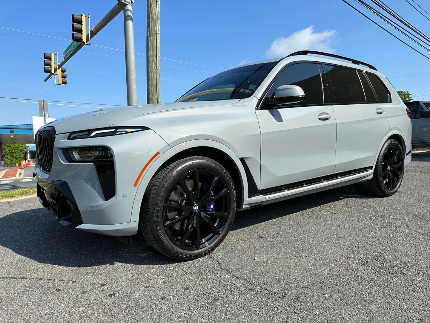 A bmw x7 is parked on the side of the road.