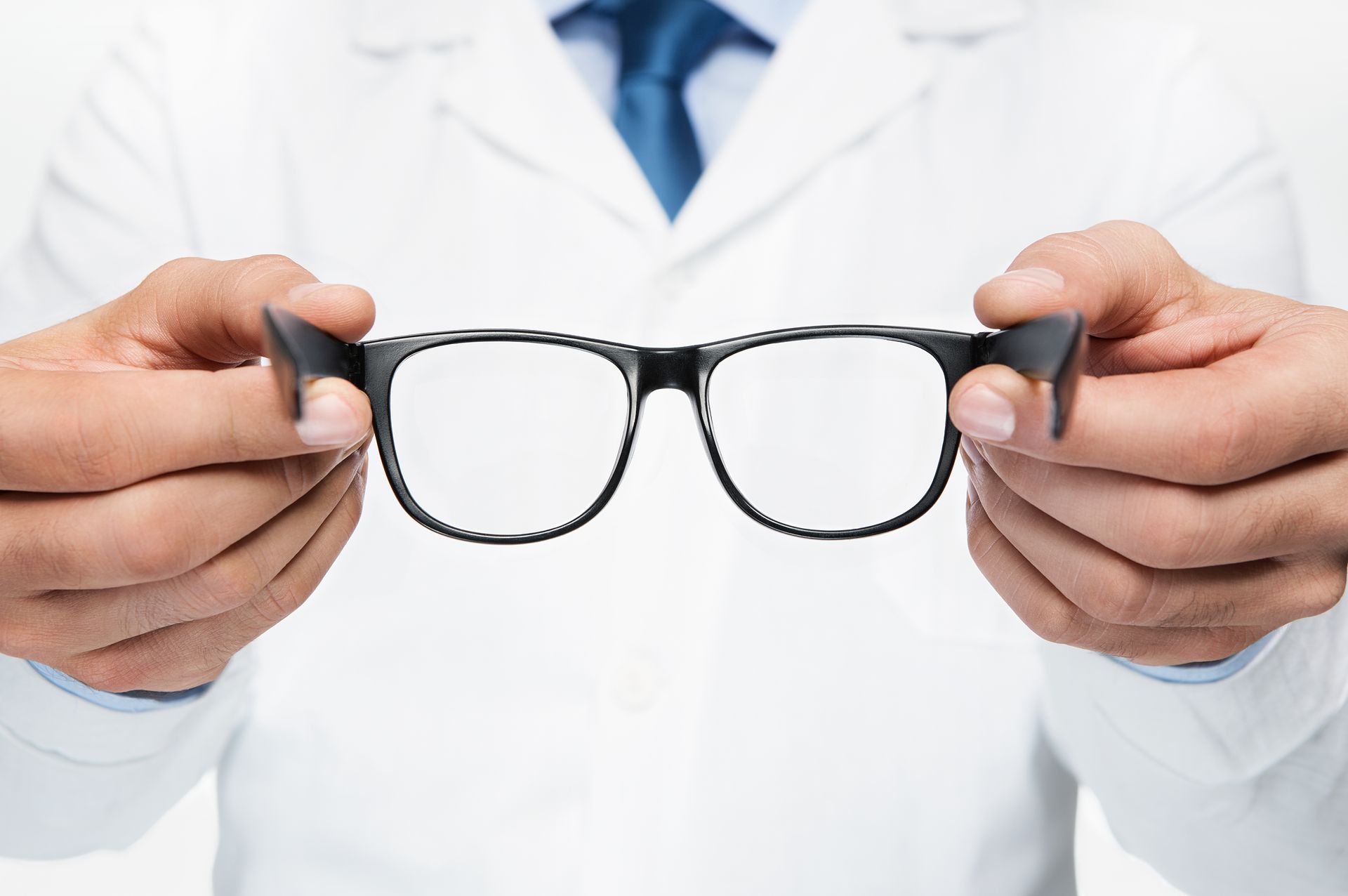 Doctor holding eyeglasses.